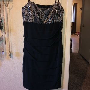 Black mini dress with spaghetti straps.